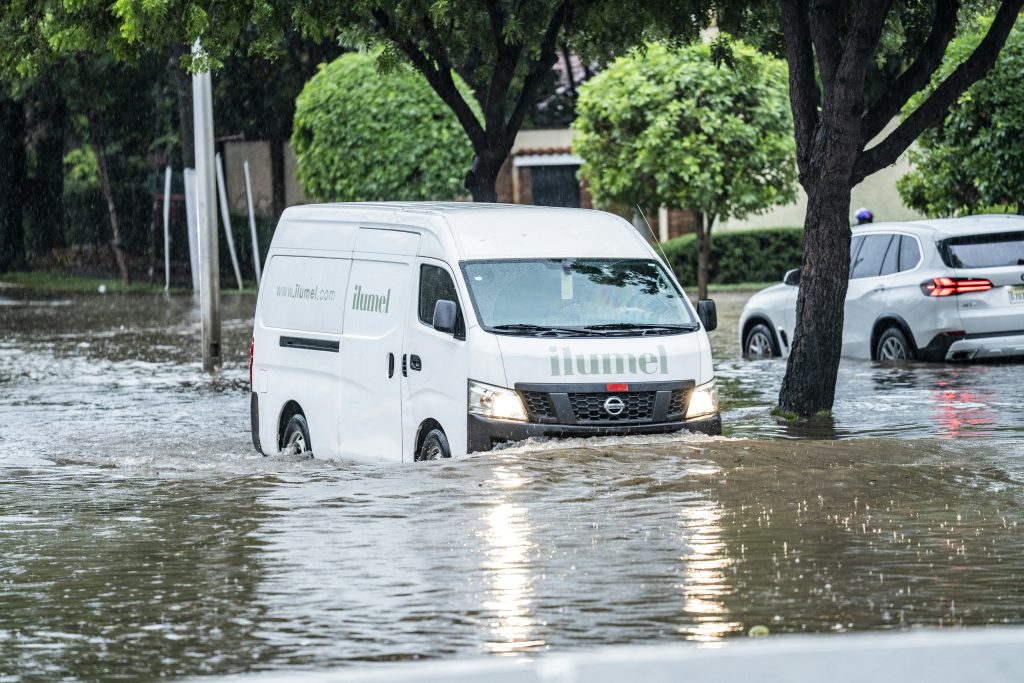 White van driving through flooded street